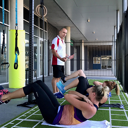 USC's Dr McKean leading a strength and conditioning session with Sunshine Coast Lightning