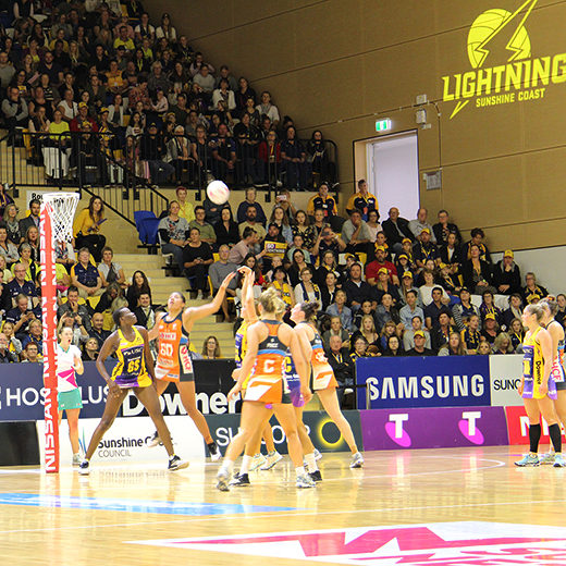 Spectators in the new eastern stand of USC Stadium enjoy the netball action on court.