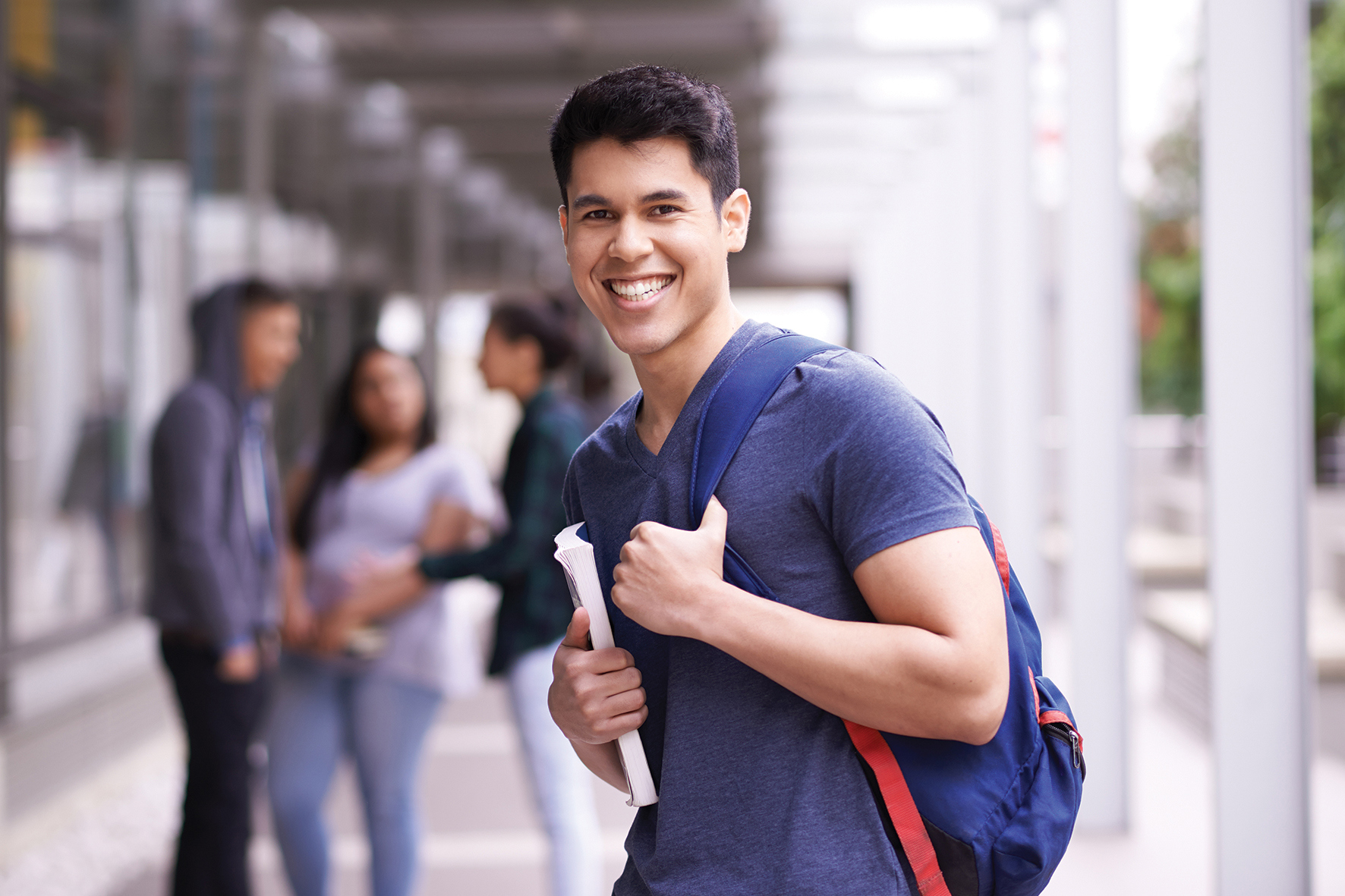 Male student with books and backpack