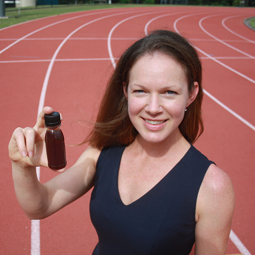 PhD graduate Meegan Walker with a shot of beetroot juice