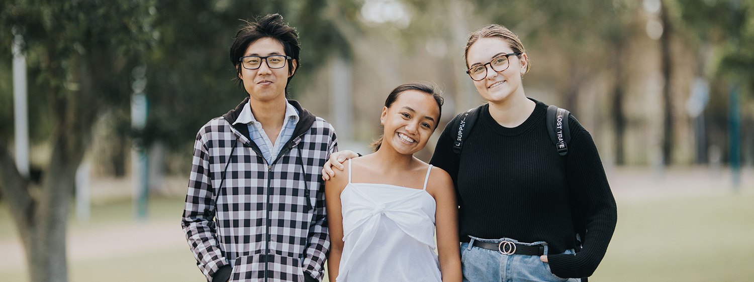 Three students looking at camera 