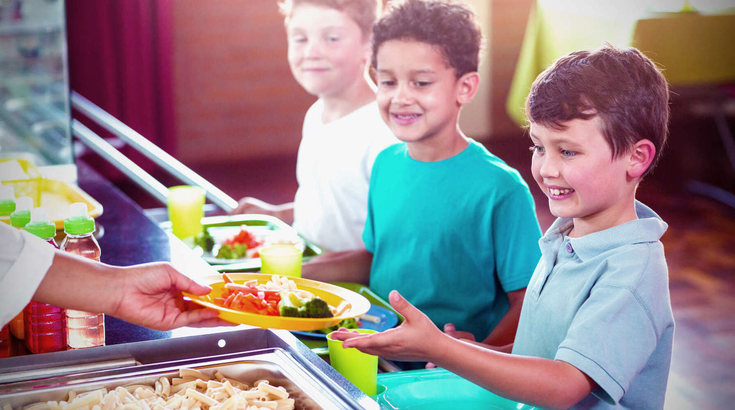 children being served lunch at school