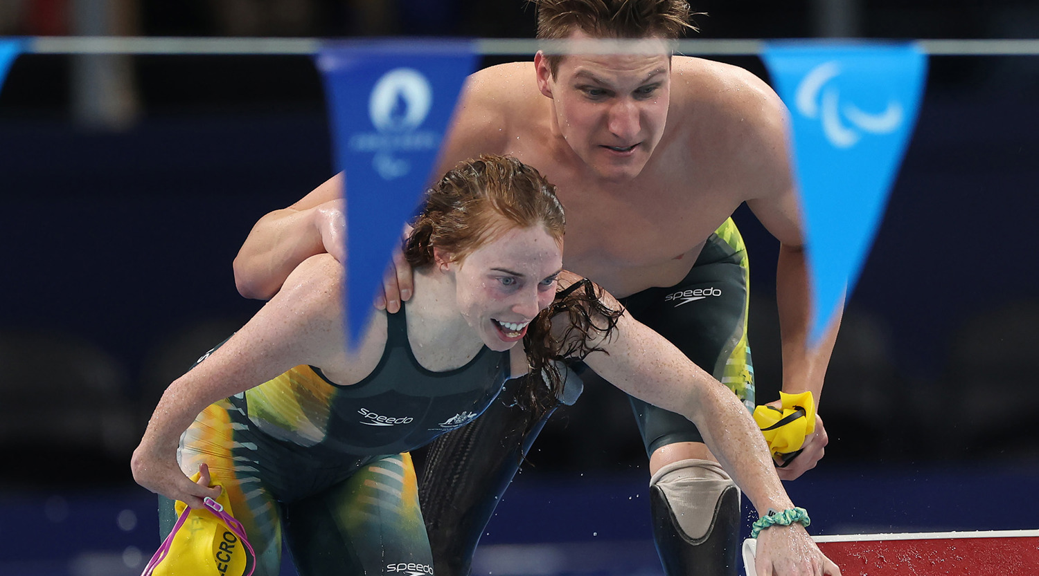 Emily Beecroft with Jesse Aungles are huddled together by the side of the pool, cheering emphatically, during the Mixed 4x100m Medley on day five of the Paris 2024 Paralympic Games Photo by Ian MacNicol-Getty Images