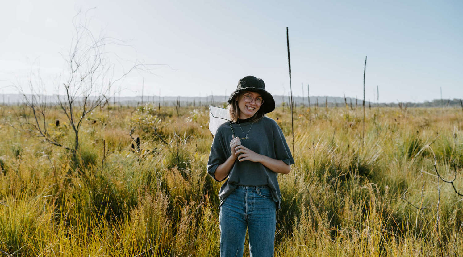 Grace Smith standing in a field similing