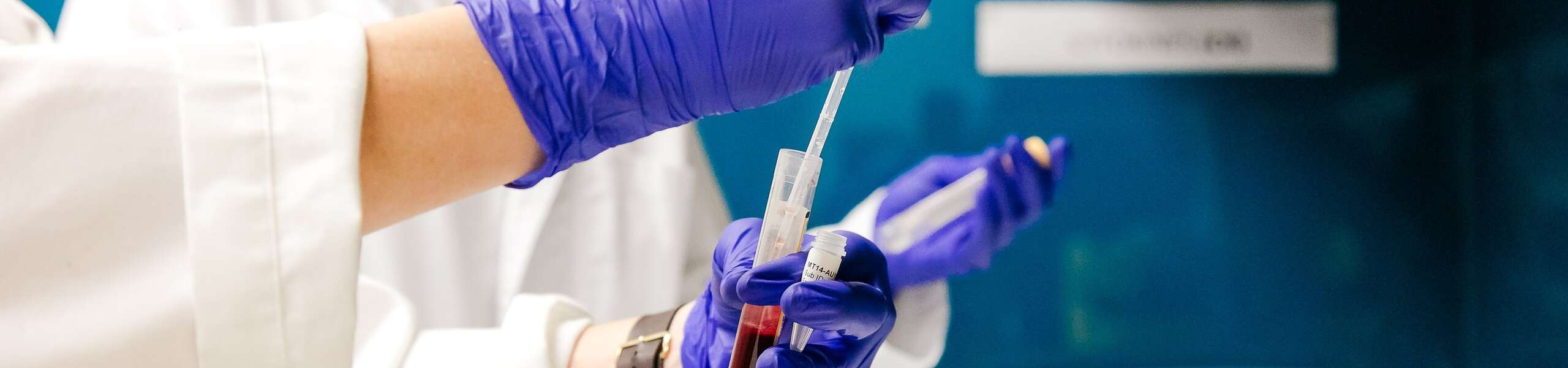 researcher with blood samples inside lab