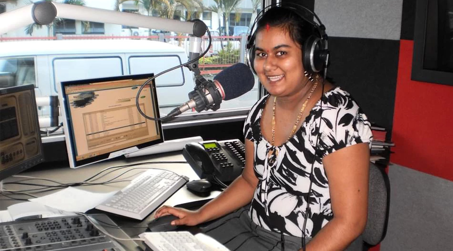 Joselyn Singh at radio desk in Fiji