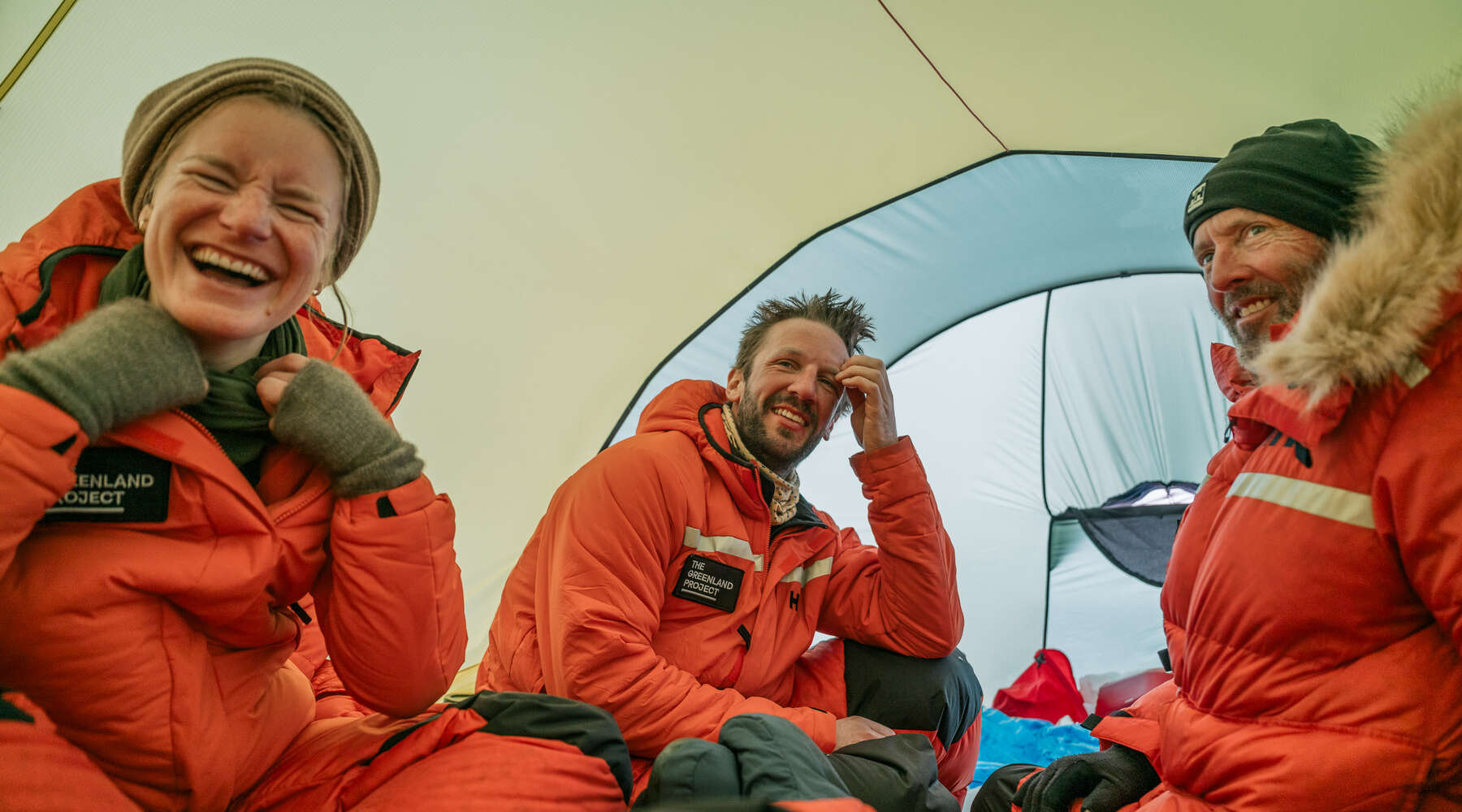 people laughing together inside a tent