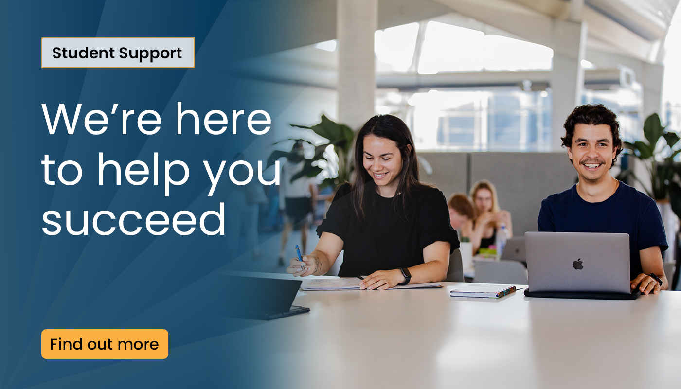 A click-through image of two smiling students sitting at a table in a library with books, a notebook, and a laptop in front of them, with words saying "Student Support: We're here to help you succeed"