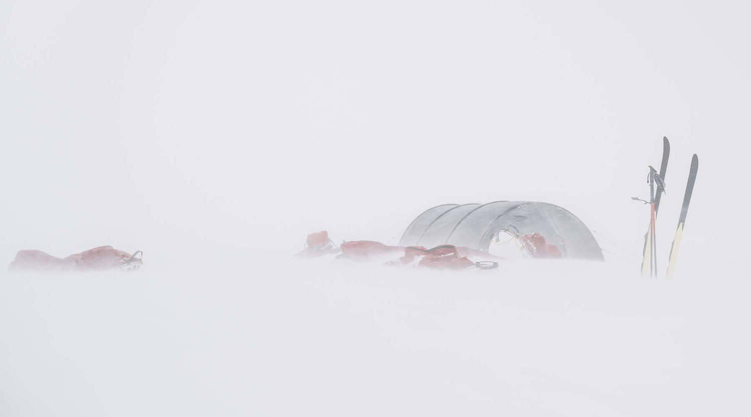 camp and skis in snow 