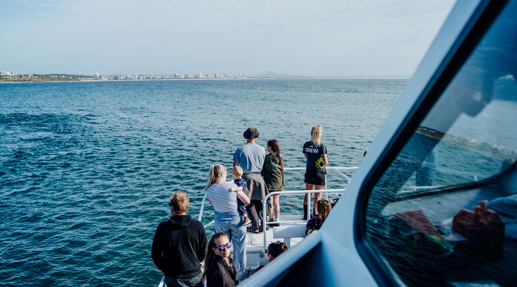 group of people on whale watching boat