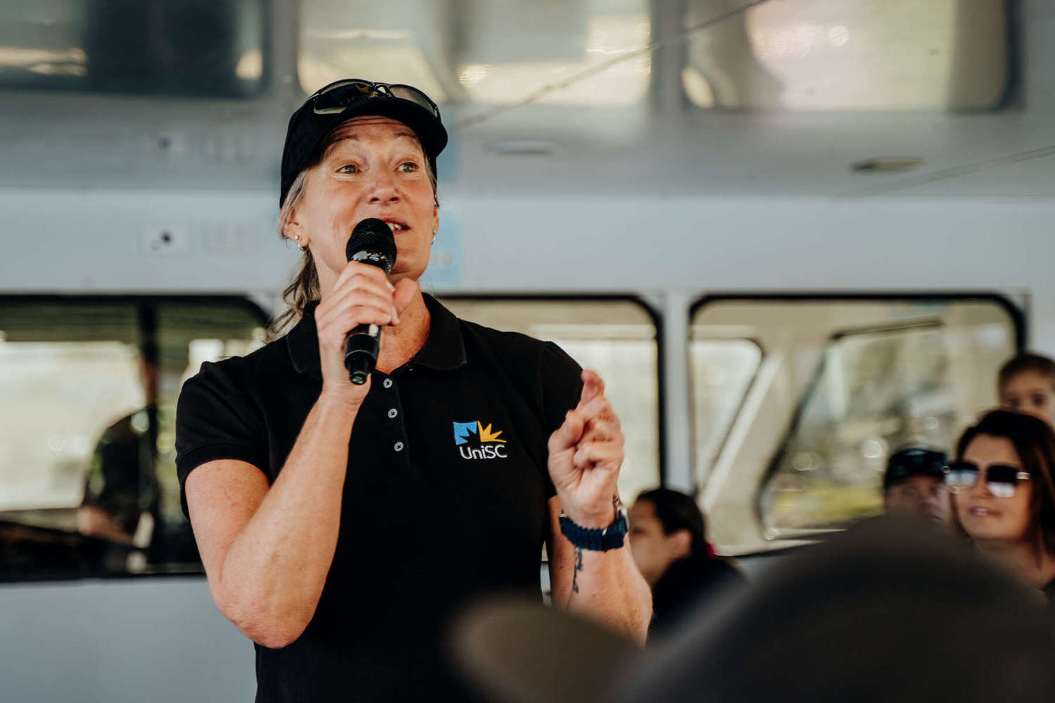 vikki schaffer presenting to crowd on whale watching boat