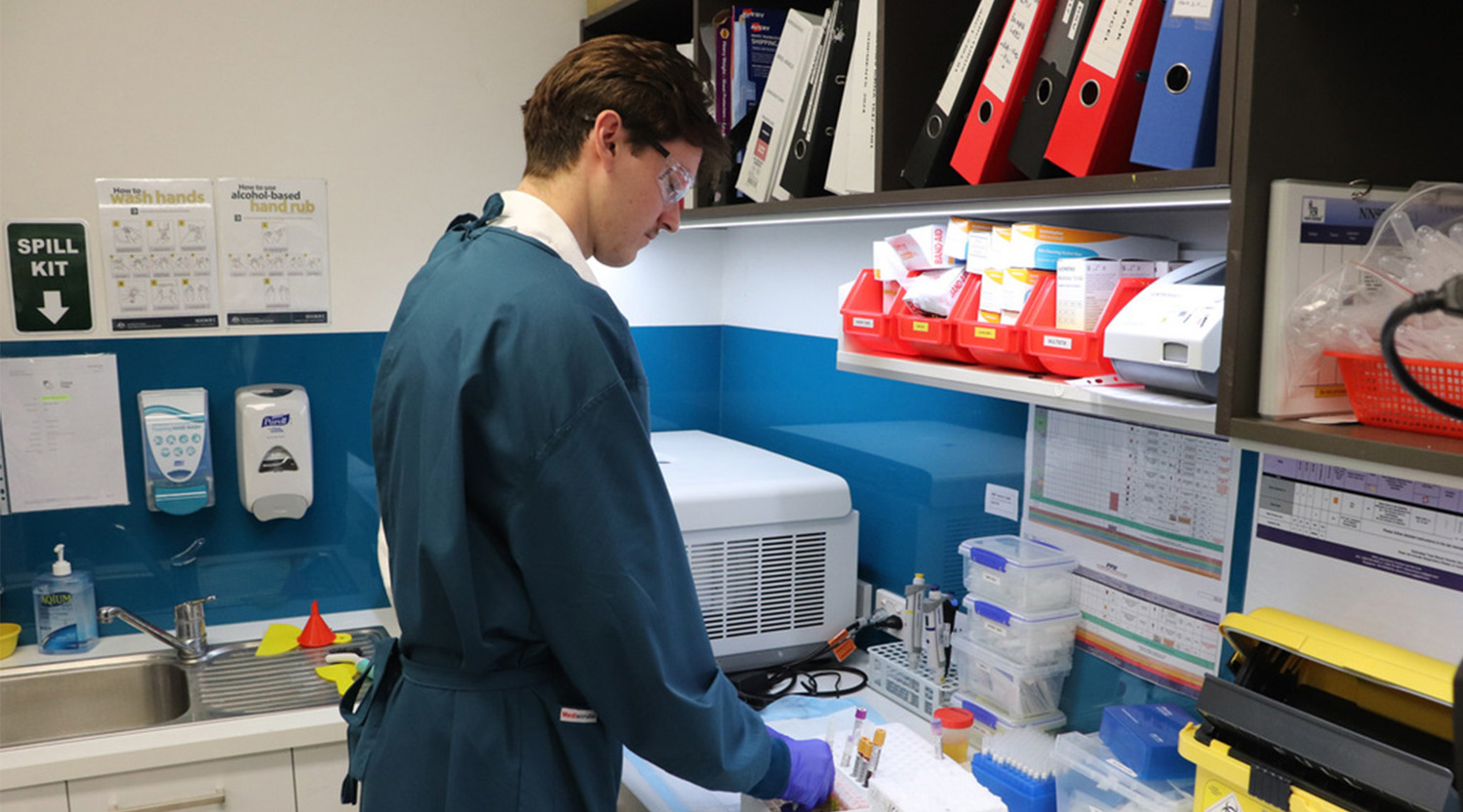 scientist inspecting samples inside a lab